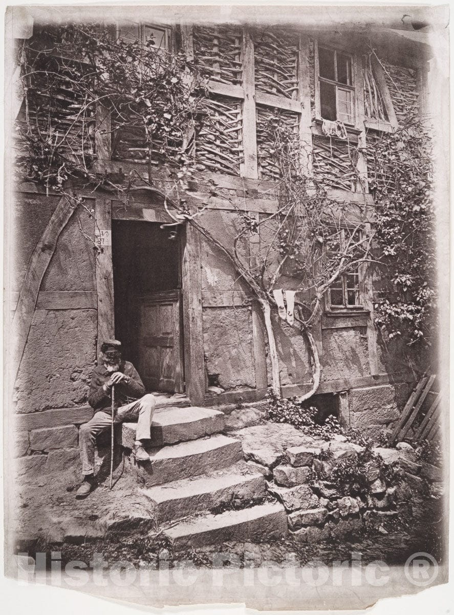 Photo Print : Man Sitting on Steps of House with Socks Hanging on Nearby Vine to Dry : Vintage Wall Art