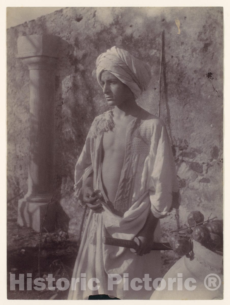 Photo Print : Wilhelm von Gloeden - Young Man in White Robe and Head Gear Holding Scabbard, Sicily, Italy : Vintage Wall Art
