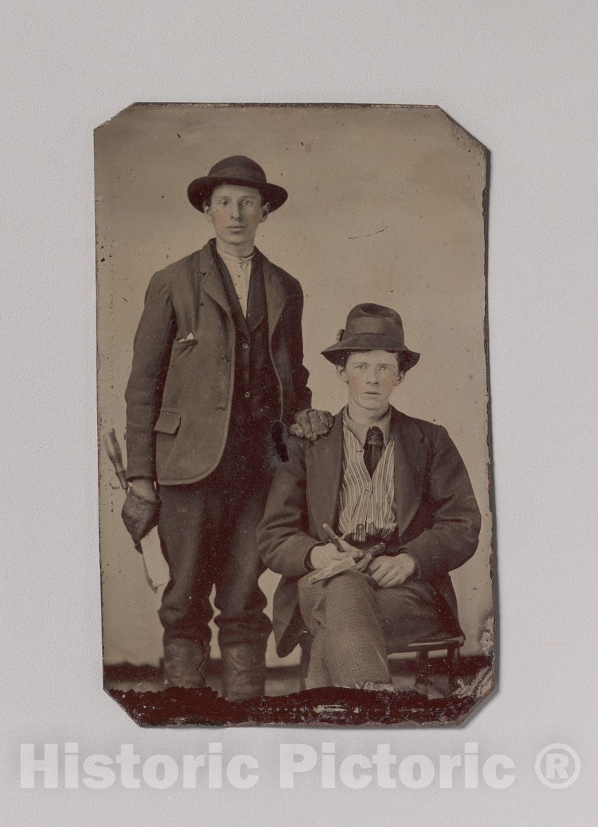 Art Print : Two Young Men, One Seated and One Standing, Holding Carpentry Tools - Artist Unknown : Vintage Wall Art