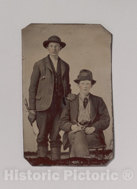 Art Print : Two Young Men, One Seated and One Standing, Holding Carpentry Tools - Artist Unknown : Vintage Wall Art