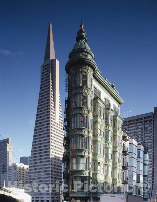 San Francisco, CA Photo - Street-level view of the flatiron Columbus Tower, also called the Sentinel Building, and the Transamerica Pyramid, San Francisco, California