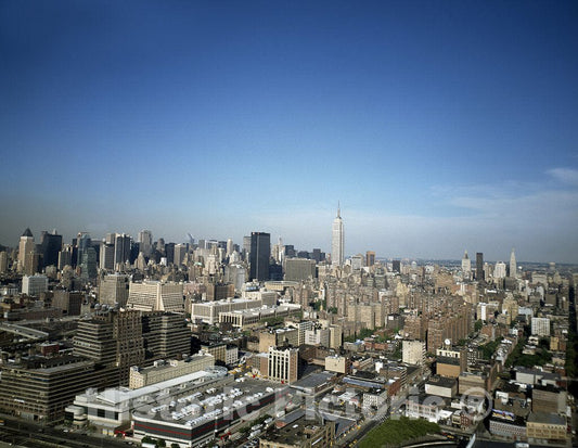 New York, NY Photo - Aerial view of midtown Manhattan, in which the Empire State Building dominates. New York, New York