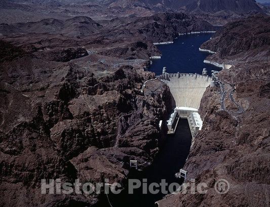 Boulder City, NV Photograph - Aerial view of Hoover Dam, near Boulder City, Nevada, with the Lake Mead National Recreation Area, which the dam's blocking of the Colorado created, in the distance