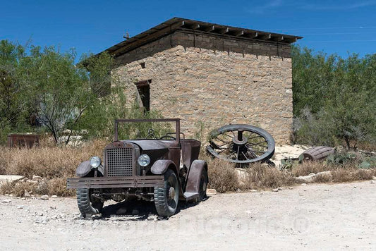 Photograph- An old jalopy outside an abandoned stone building in the"ghost town," some of which is still occupied and some of which consists of ruins of the Chisos quicksilver-mining company