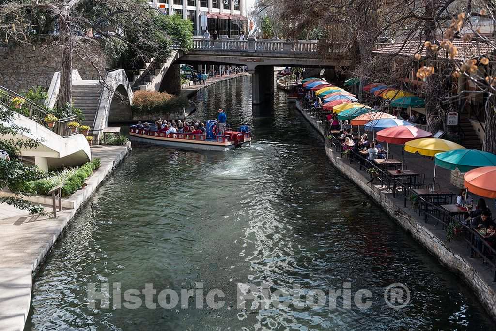 Photo - Restaurant Outdoor Seating Umbrellas and a Passing Tourist Barge at The River Walk, Also Known as The Passeo del Rio- Fine Art Photo Reporduction