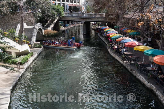 Photo - Restaurant Outdoor Seating Umbrellas and a Passing Tourist Barge at The River Walk, Also Known as The Passeo del Rio- Fine Art Photo Reporduction