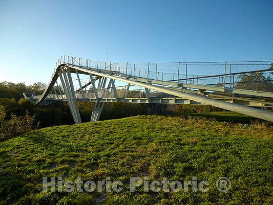 Photo- The CONSOL Energy Wingtip Bridge, a pedestrian bridge with a main walkway and two others bending above and below that surmounts a 100-foot ravine at the Summit Bechtel Reserve