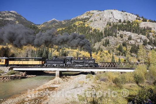 San Juan County, CO Photo - A Durango & Silverton Narrow-Guage Scenic Railroad train, pulled by a vintage steam locomotive, crosses an alpine bridge in San Juan County, Colorado. -