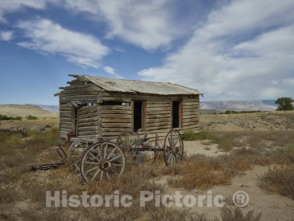 Big Horn County, Wyoming Photo - Old Cabin and Buckboard Wheels in Big Horn County, Wyoming.