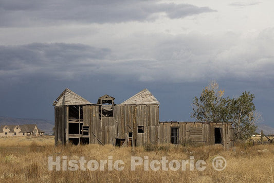 Antonito, CO Photo - Fairly new distant, and old and decrepit foreground structures in the town of Antonito in Conejos County, Colorado, near the New Mexico border.