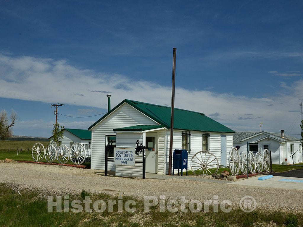 Photo - The exterior decor consists mostly of wagon wheels at the U.S. Post Office in Powder River, Wyoming- Fine Art Photo Reporduction