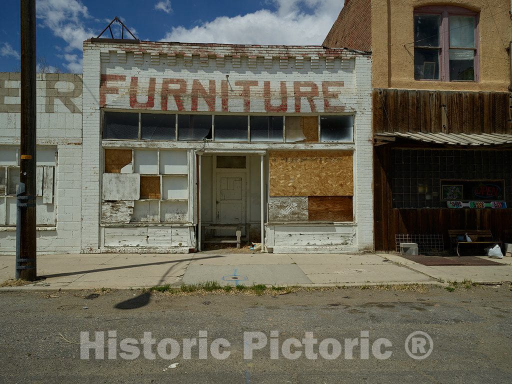 Photo - Perhaps The Furniture Sold at This Store in Shoshoni, Wyoming, did not sag. But The Sign Above The Door Does Now That The Store is Long-Closed- Fine Art Photo Reporduction