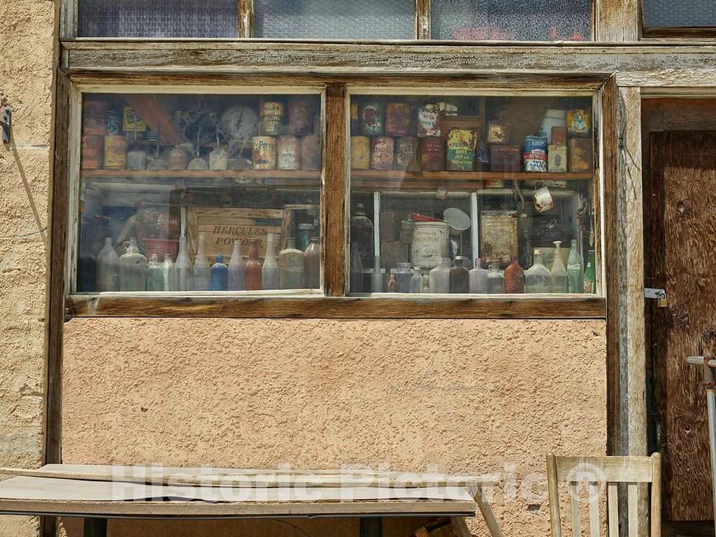 Photo - A tableau of bottles and cans in the window of a long-abandoned place of business in Shoshoni, Wyoming- Fine Art Photo Reporduction