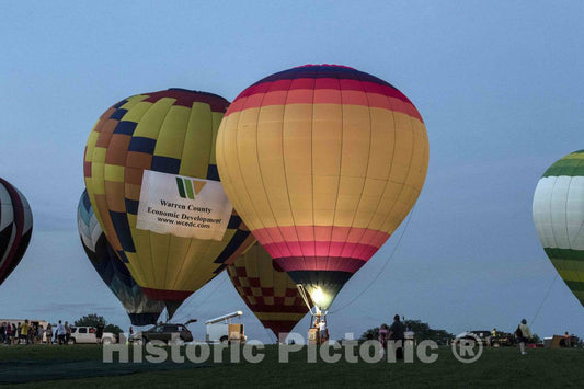 Photograph- Hot air balloons begin their descent above the cornfields of Warren County, Iowa, at the National Balloon Classic, an exhibition in Indianola, near the state capital of Des Moines