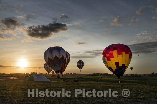 Colorful balloons delight the assembled crowd with a night glow as pilots fire the burners on the ground at the National Balloon Classic,  9