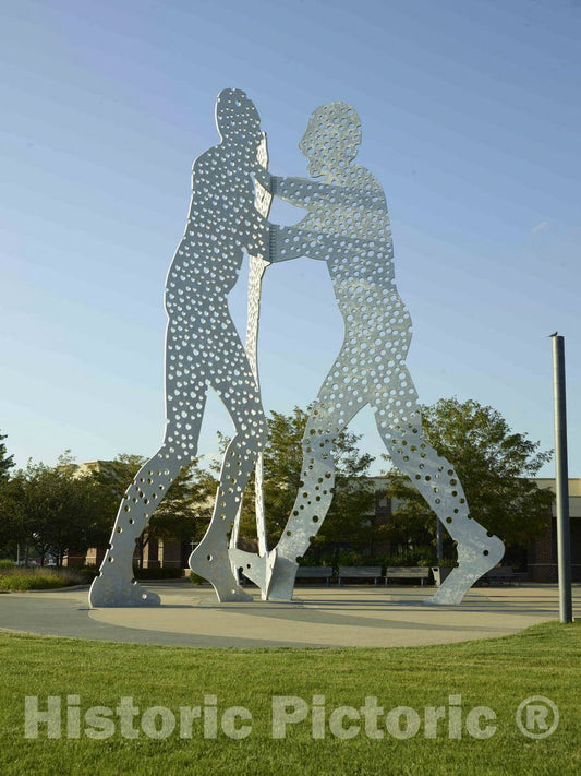 Photo -"Molecule Man", Expectedly three perforated figures combining to make one sculpture, in Council Bluffs, Iowa, a city that calls itself a place"where art lives"