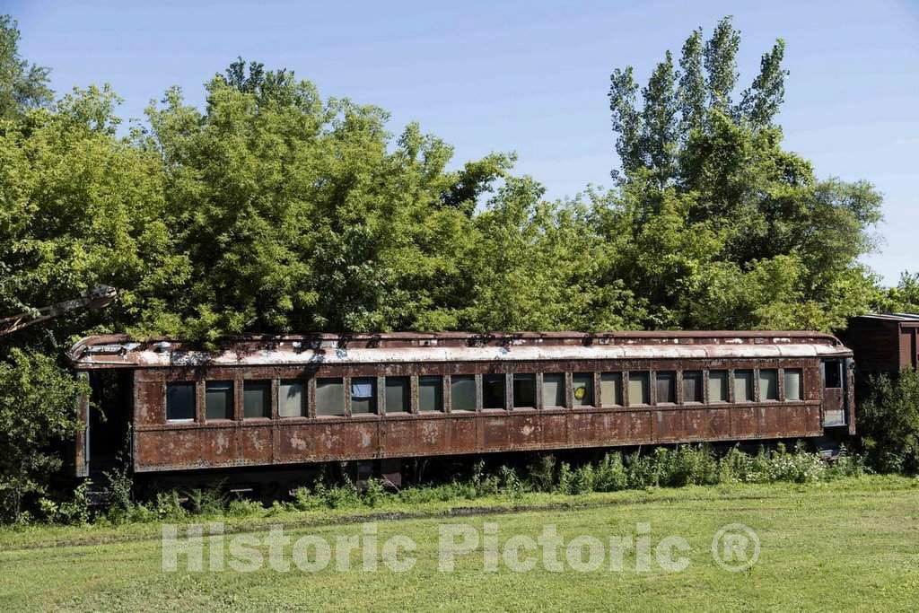 Photo - Abandoned and overgrown railroad passenger coach on the grounds of the Boone & Scenic Railroad, an excursion railway operating out of Boone, Iowa