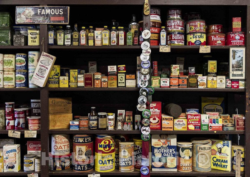 Photo- Vintage merchandise at the 1891 Burlingame's General Store, part of the Froelich 1890 Village Museum near McGregor, Iowa, that includes a tractor display, a one-room school