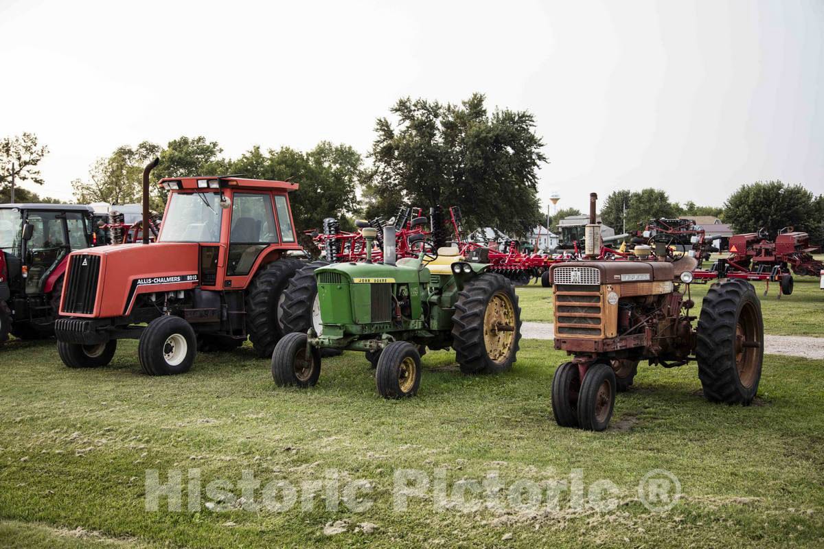 Photo - Old and New Tractors Stand Wheel by Wheel at a Farm-Implement dealership in Dumont, Iowa- Fine Art Photo Reporduction