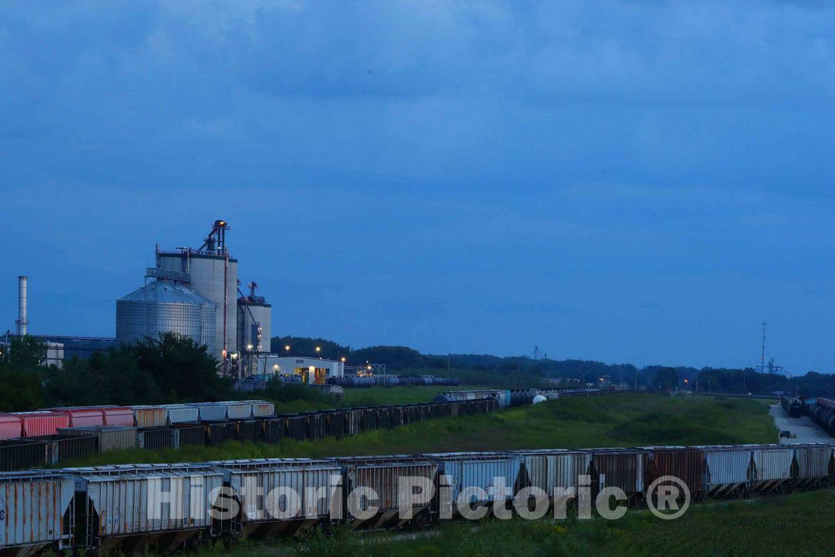 Photo - Dusk Settles Over an Agricultural Processing Facility and Endless Strings of Railroad Freight Cars in Butler County, Iowa- Fine Art Photo Reporduction