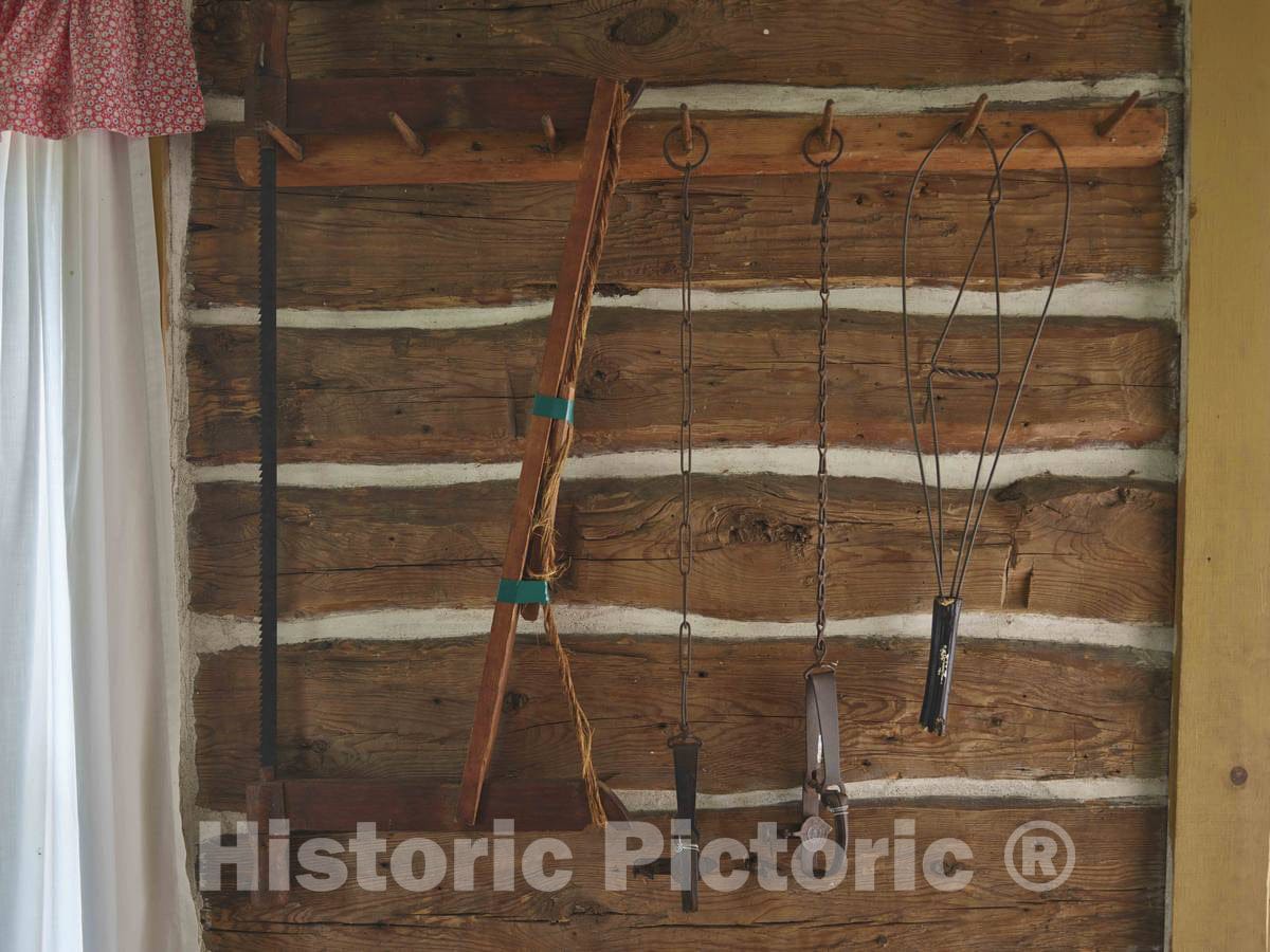 Photo- Everyday objects that were part of pioneers' lives on the prairie, are displayed on a wall of the Lars Anderson Cabin at the Chippewa Valley Museum in Eau Claire, Wisconsin