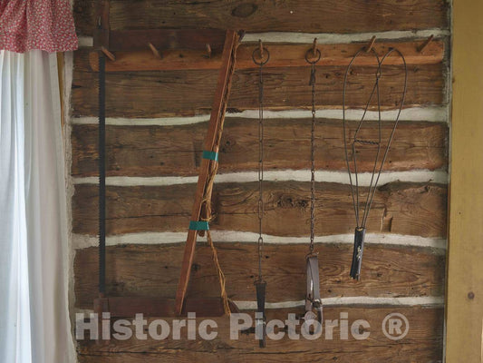 Photo- Everyday objects that were part of pioneers' lives on the prairie, are displayed on a wall of the Lars Anderson Cabin at the Chippewa Valley Museum in Eau Claire, Wisconsin