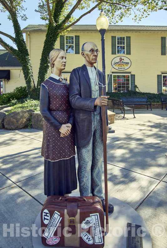 Photo- Grant Wood's Classic American Gothic Figures reimagined as one of The 11 installations of Life-Sized Trompe L'Oeil Painted Bronze Statues Around Crown Point, Indiana