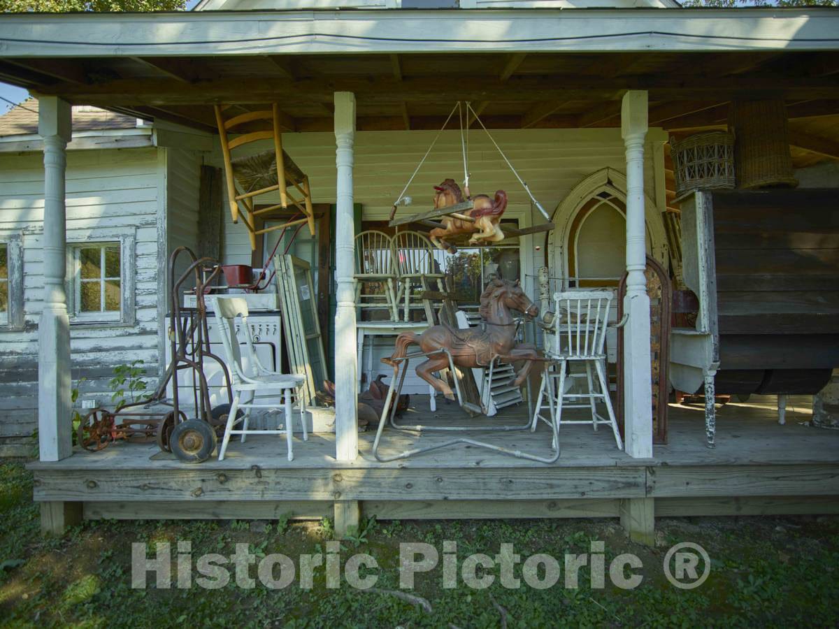 Photo- The porch that confirms the premesis's name, Old Stuff Antiques, in Nashville, a small south-central Indiana city with a growing reputation as an art and collectibles center