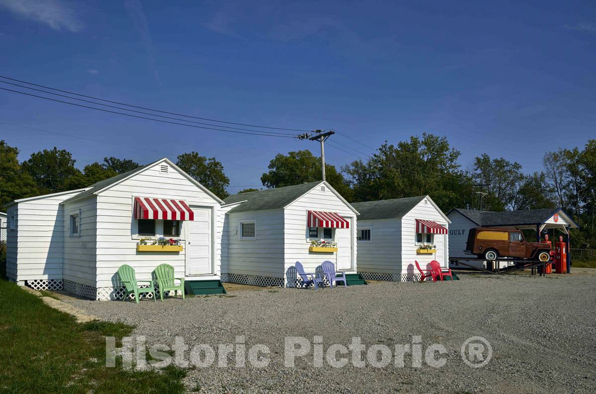 Photo- Relocated early tourist cabins from the early days of travel along the American road, now displayed outside the National Automobile and Truck Museum in Auburn, Indiana