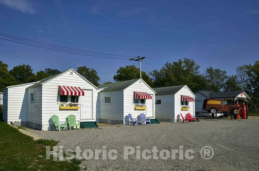 Photo- Relocated early tourist cabins from the early days of travel along the American road, now displayed outside the National Automobile and Truck Museum in Auburn, Indiana