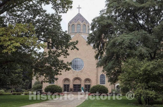 Photo- Sunday morning services having just concluded, a priest prepares to greet departing parishioners outside the Church of Loretto at Saint Mary's College, a four-year, Catholic