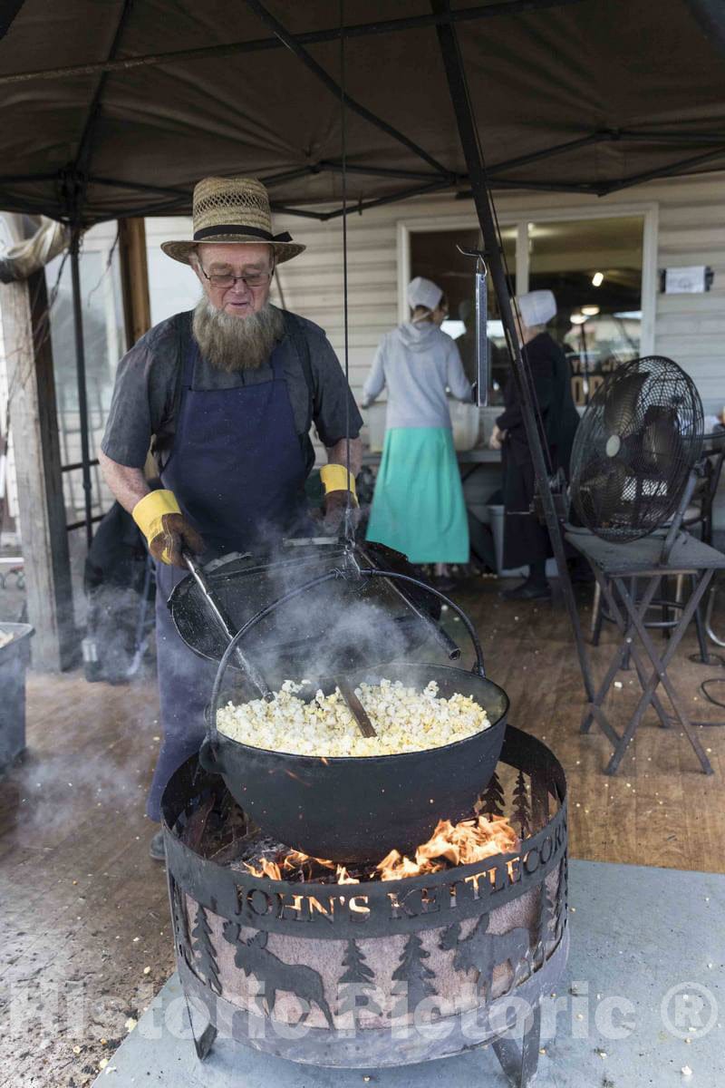Photo - An Amish man tends to popcorn, prepared over an open fire at Hershberger's Farm and Bakery- Fine Art Photo Reporduction