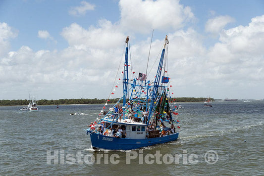 Photograph- The shrimp boat Seahorse, loaded with more than crustaceans and crew, passes by at the annual Blessing of the Fleet of shrimp boats in the Atlantic Coast city of Mount Pleasant