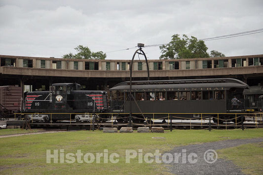 Photograph- A vintage train makes a turn at the Georgia State Railroad Museum turntable on the grounds of the old Central of Georgia Railway Savannah Shops and Terminal facilities in Savannah