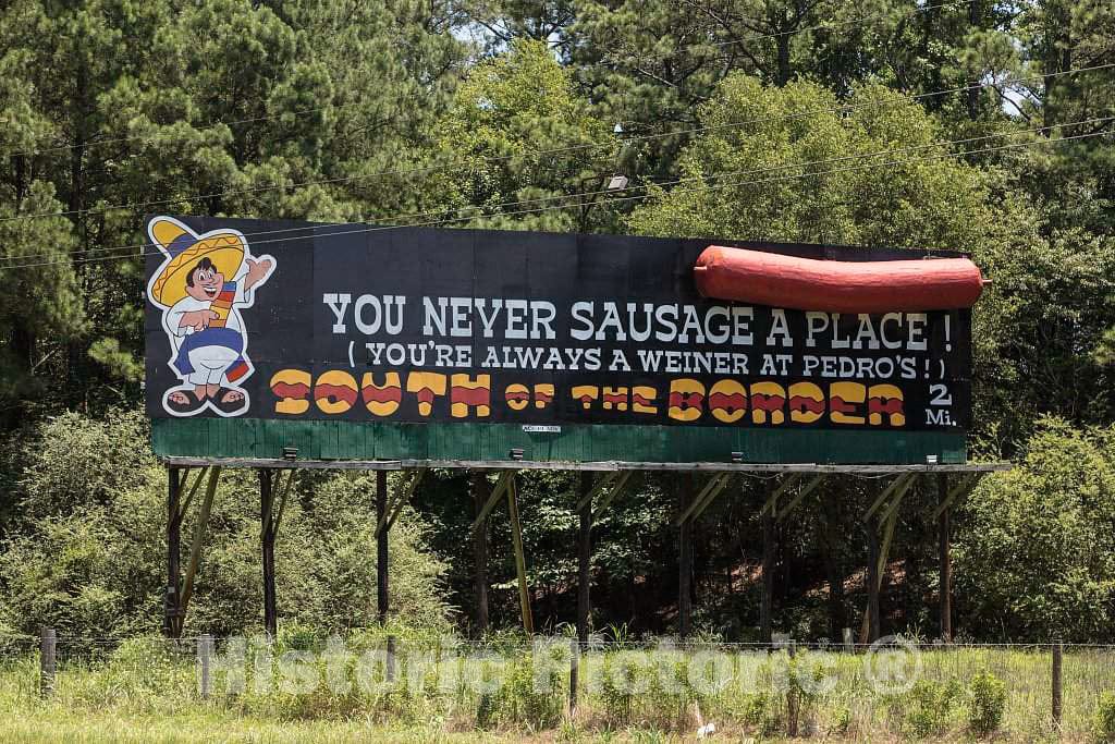 Photo- Catchy Sign touting an Attraction just Ahead on The Highway: an Unapologetically Tourist-Centered Shopping Extravaganza, with a Theme-Park Flair but Minus The Rides