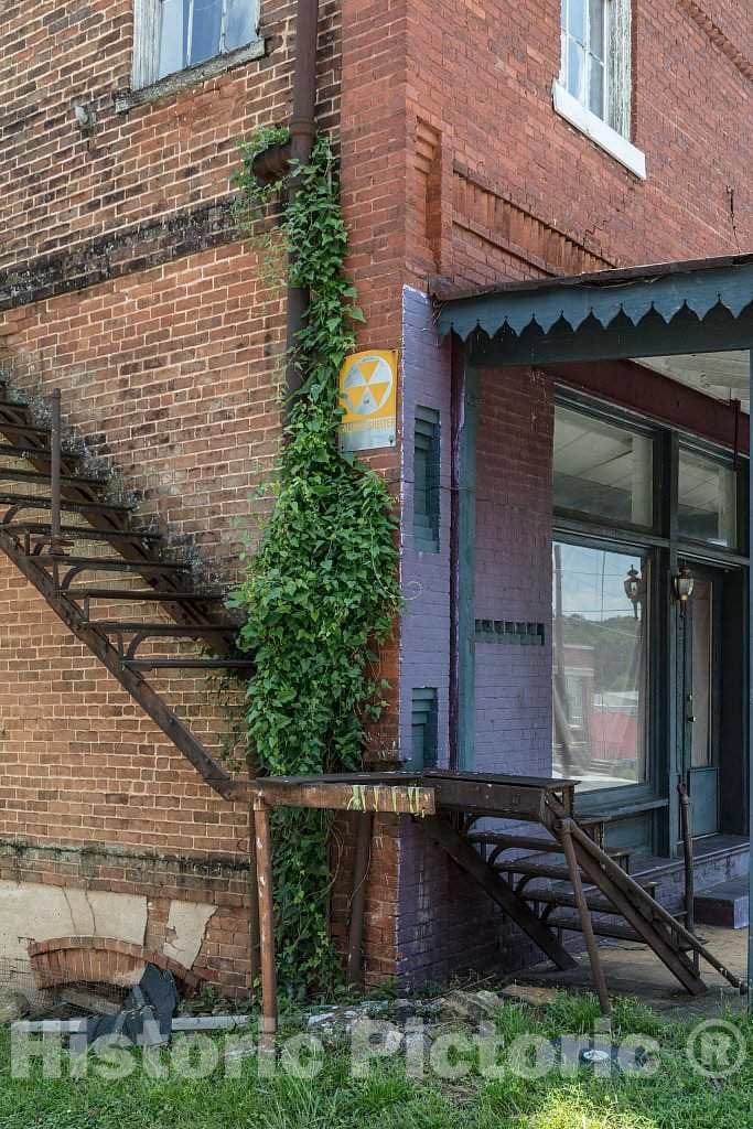 Photograph- At first glance, the rusted-out staircase leading from the front porch of this old, abandoned building in Jefferson, Georgia, would seem to lead nowhere, to a five-foot dropoff or