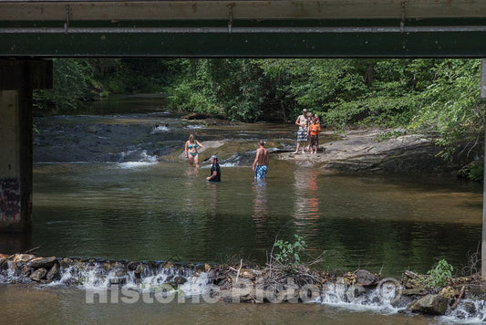 Photo- A family and friends enjoy a cool swim on a hot summer day beneath the Stovall Covered Bridge outside a White County, Georgia, town with a most unusual name: Sautee Nacoochee