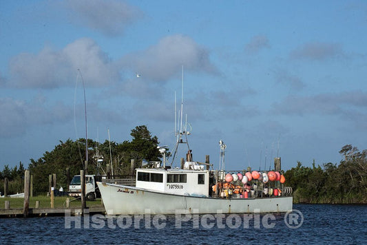 Photo- Shellfish boat loaded with buoys to mark traps in Wanchese, an old fishing port, and in fact, the very first fishing village on Roanoke Island in North Carolina's Outer Banks