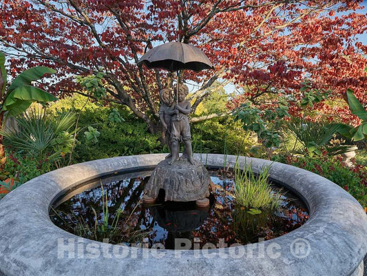 Photo- The 1913"Out in the Rain" statue and masonry pool at the Oakland Cemetery in Atlanta, Georgia, once the principal burial ground for Atlanta residents, travelers, and paupers