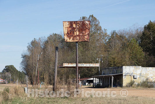Photo - A Now-unreadable, Rusted Metal Sign Once advertised The Long-Closed Sunny's Gasoline Station and Country Store Store Outside Batesville, Mississippi