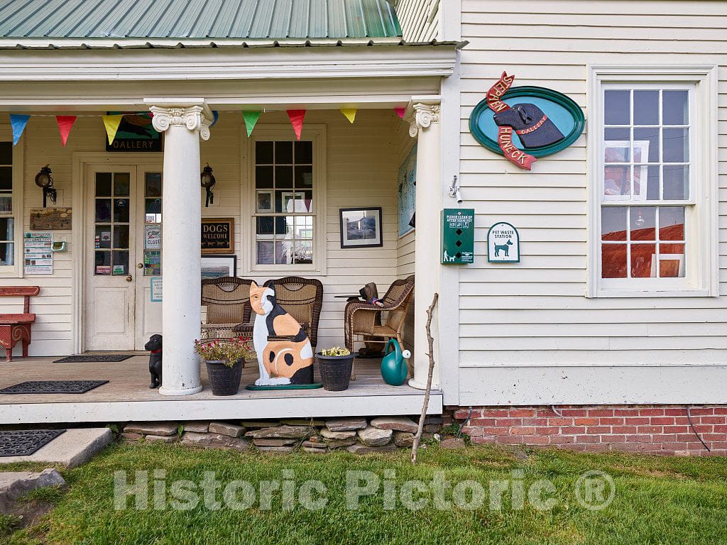 Photo- Gift shop porch at the Dog Chapel, indeed, a quite serious chapel devoted to departed and/or beloved canine pets. (Note an apparently approving feline figure there as well