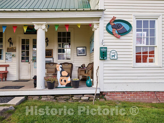 Photo- Gift shop porch at the Dog Chapel, indeed, a quite serious chapel devoted to departed and/or beloved canine pets. (Note an apparently approving feline figure there as well