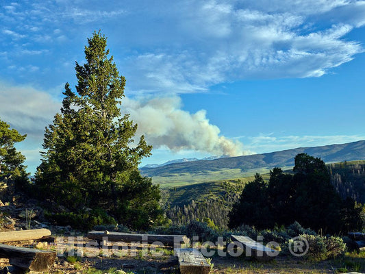 Photo- Smoke from More Than a Campfire Rises into The Sky in The Distance as seen from The Cookout Area of The A Bar A Guest Ranch, Near Riverside in Carbon County, Wyoming