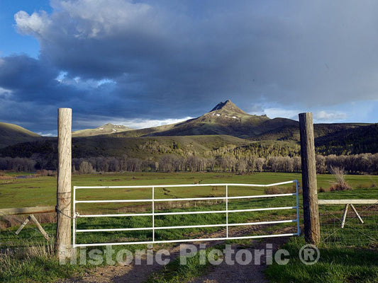 Photograph- The distant Squaw Mountain looms over this gate to the Ladder Livestock Ranch near the tiny town of Savery, Wyoming, across the highway from which lie Colorado and the mountain